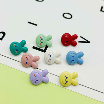 Colorful cartoon rabbit buttons set, round faces with two ears and small star cutout