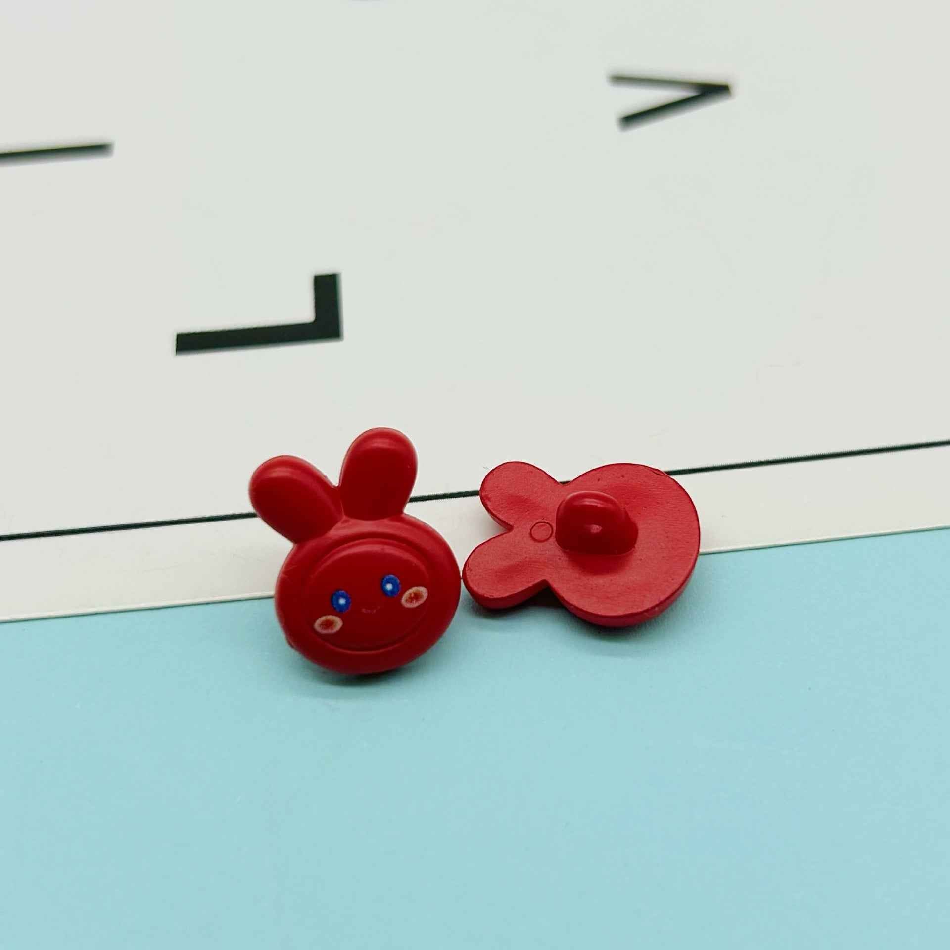Red cartoon rabbit buttons: bunny face with ears and red flower-shaped bow button