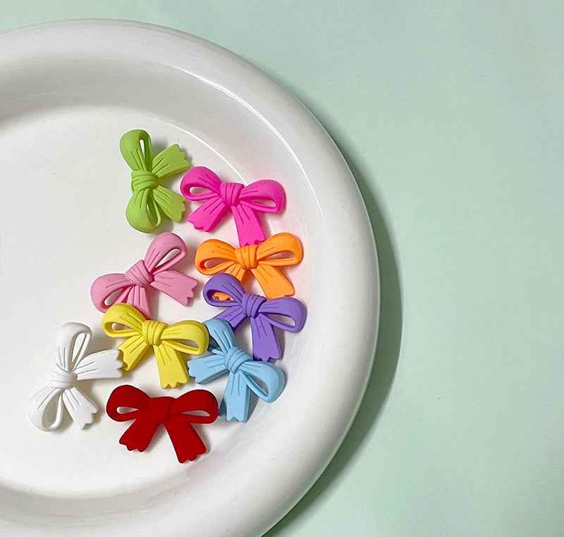 Colorful 28mm plastic bow buttons pack: green, pink, orange, purple, yellow, red