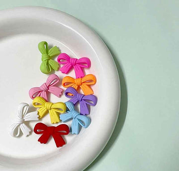 Colorful 28mm plastic bow buttons pack: green, pink, orange, purple, yellow, red