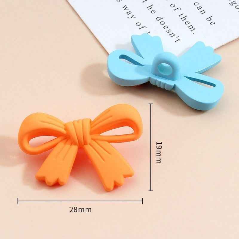 28mm x 19mm orange bow plastic button with light-blue bow top