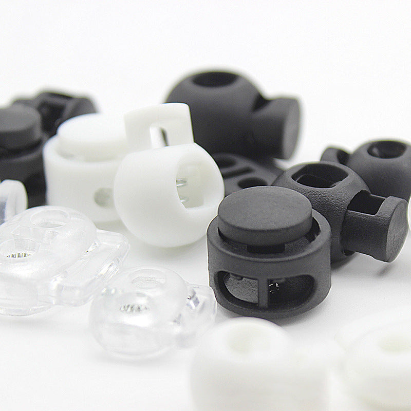 Kordelstopper-Mix: weiße und schwarze Kunststoff-Slider mit Federkern