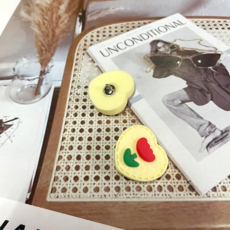 Yellow heart plastic button pair with decorative red heart and green leaf