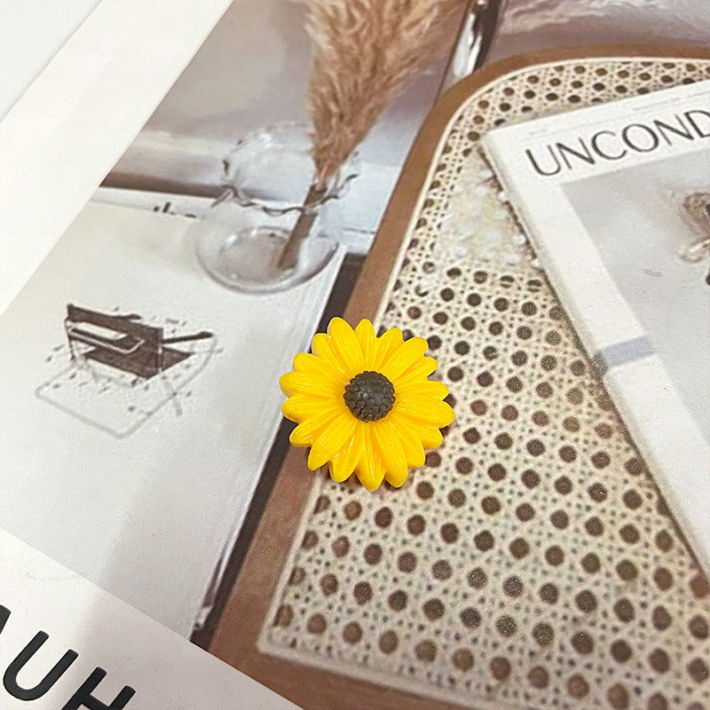 Yellow sunflower plastic button with dark center