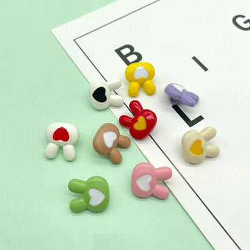 Assorted colorful cartoon bunny plastic buttons with heart centers in white, red, green, pink