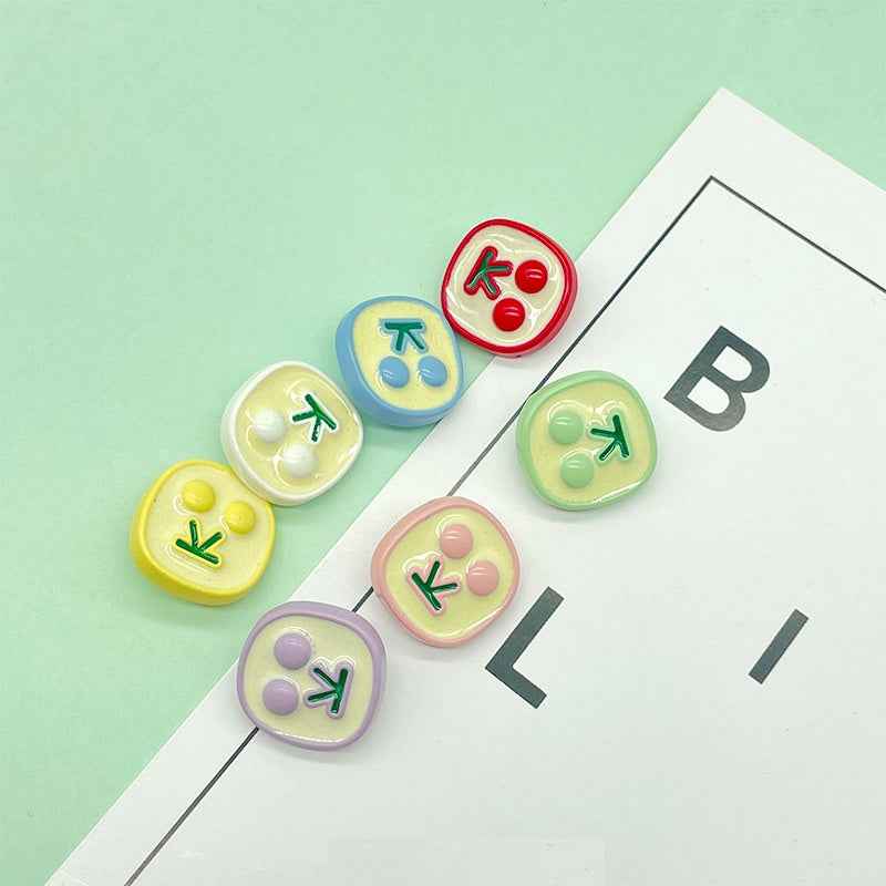Colorful square epoxy buttons with cherry icons: red, blue, yellow, green, pink