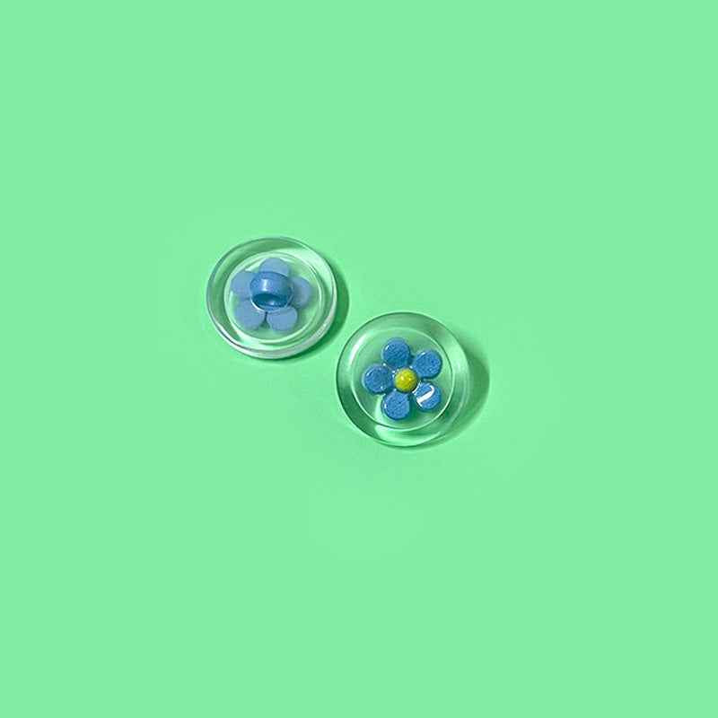 Blue flower transparent plastic shank buttons with yellow center, round two-tone (2 shown)