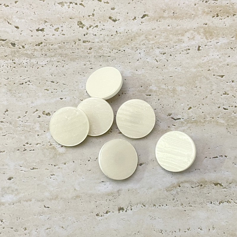 Beige round flat resin buttons, smooth textured fronts with metal shanks