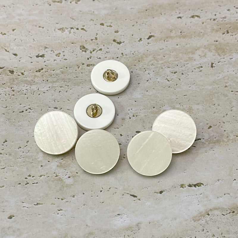 Set of beige flat resin buttons with metal loops on the back