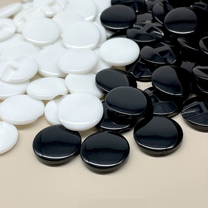 Black and white resin concealed-hole buttons, round discs with center slot