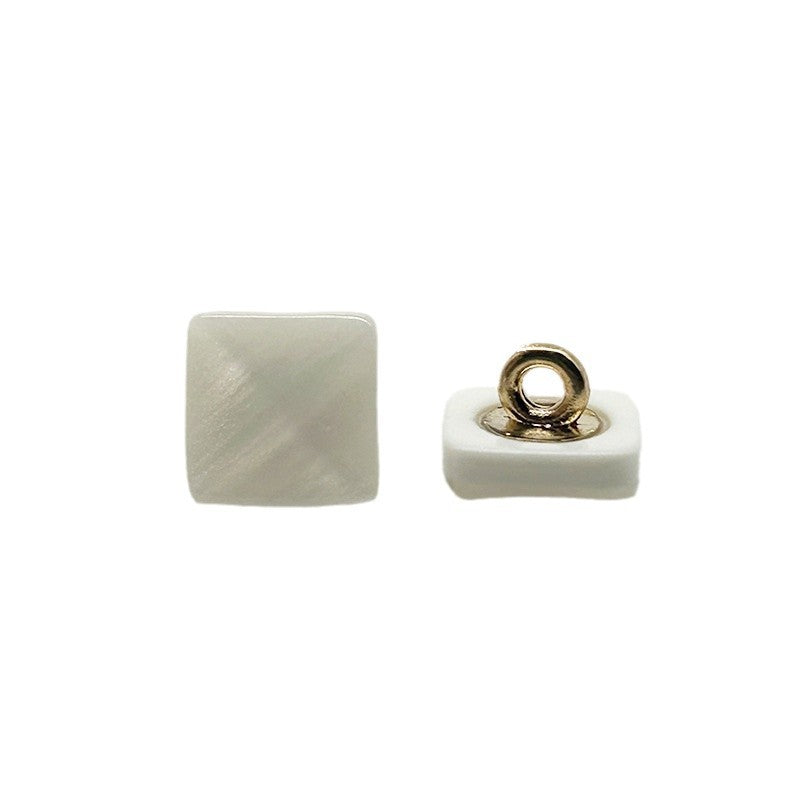 White square pyramid resin shank button with gold-tone loop, side view