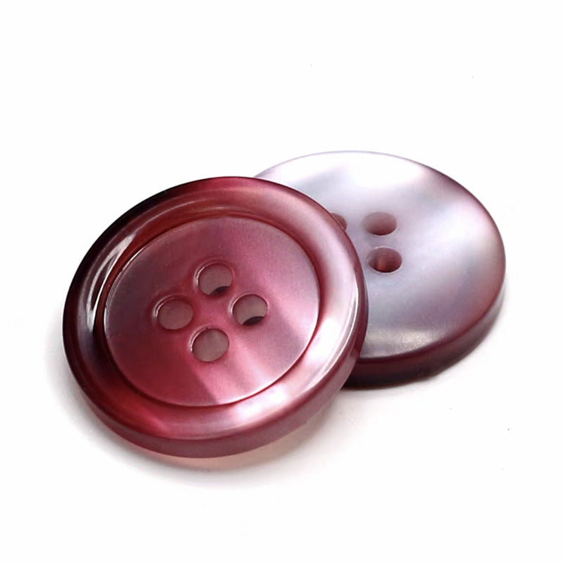 Red-pink round gradient resin button with four holes, glossy pearlized finish