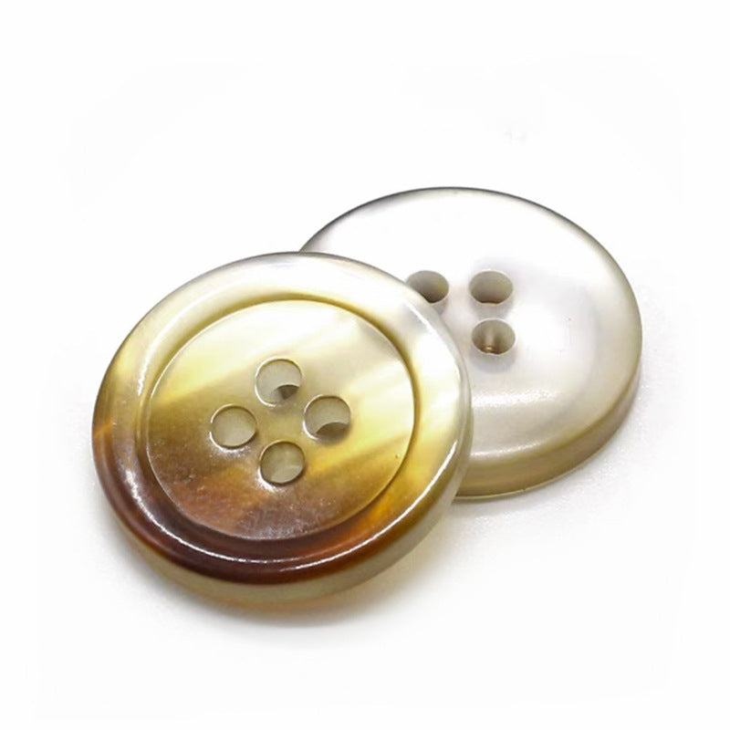 Cream-and-amber round gradient resin button with four holes, glossy pearlized finish