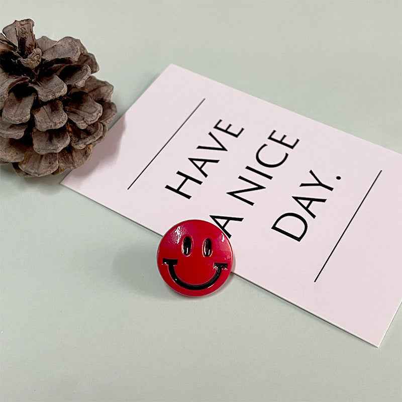 Red round smiley face button with shank