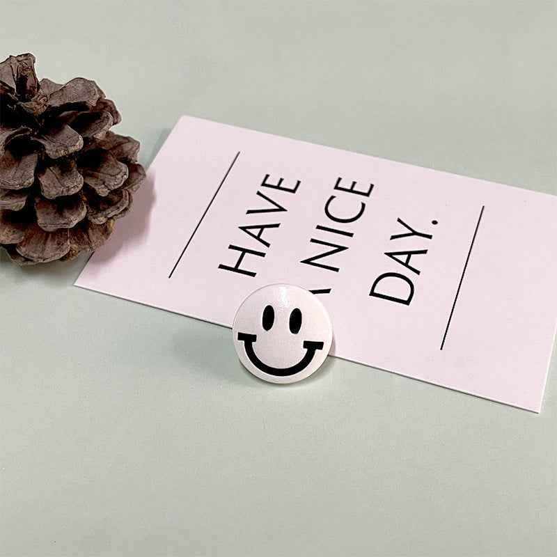 White round smiley face button with shank