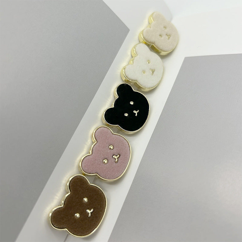 Teddy bear buttons in white, black, pink, and brown with gold-tone edges