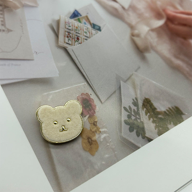 Beige teddy bear metal button with flannelette face and gold-tone outline