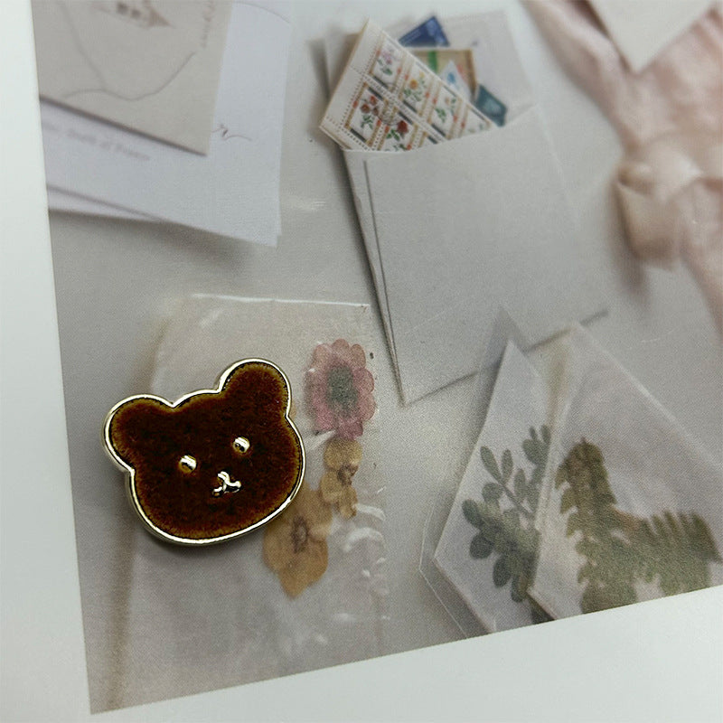 Brown teddy bear metal button with flannelette face and gold-tone outline