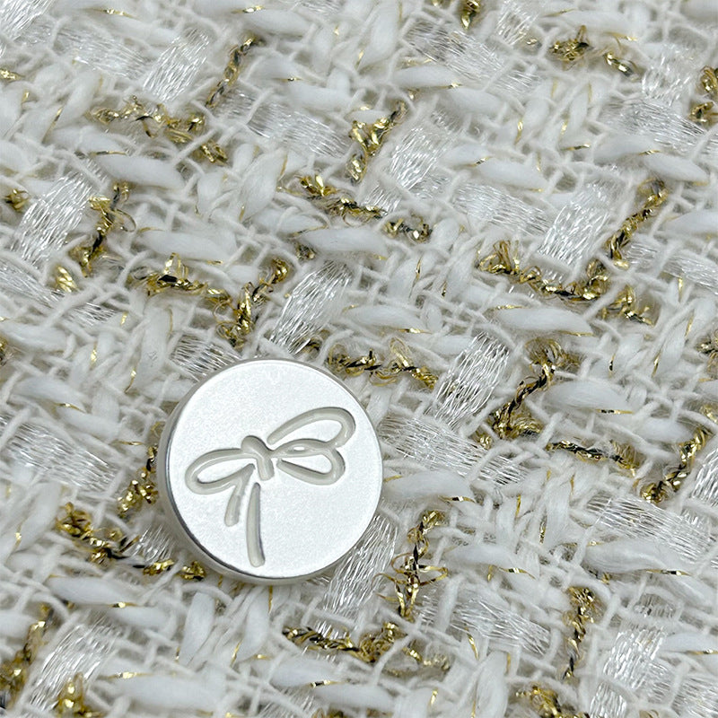 Black-outlined bow-knot painted metal flat button with shank, round silver face