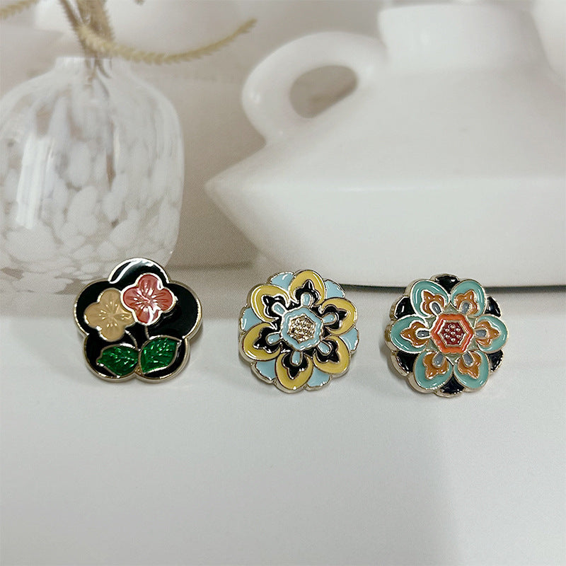 Court-style enamel coat buttons with multicolor floral motifs and small pearl-like centers