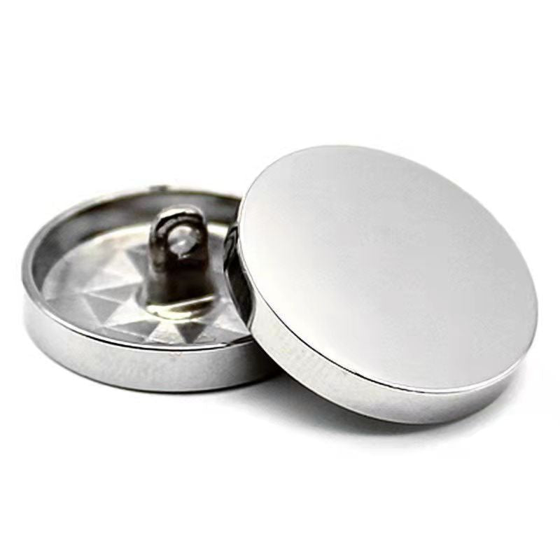 Bright silver round sewing button with shank, mirror-finish face, flat back view