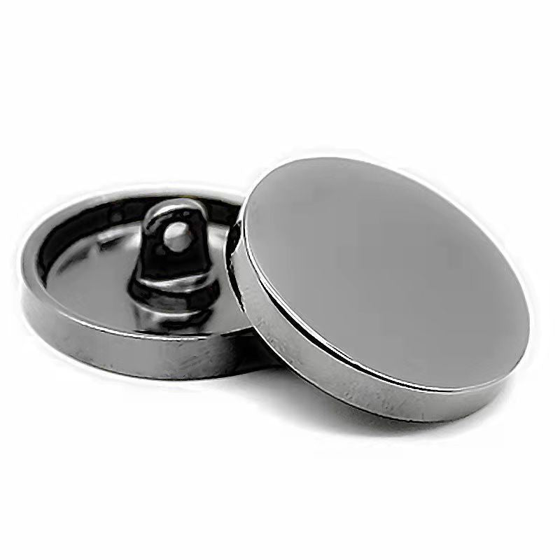 Silver round sewing button with shank, mirror-finish face, flat back view