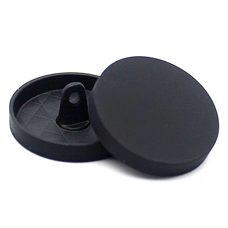 Black round sewing button with shank, mirror-finish face, flat back view