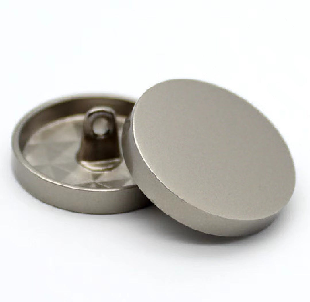 Gunmetal round sewing button with shank, mirror-finish face, flat back view
