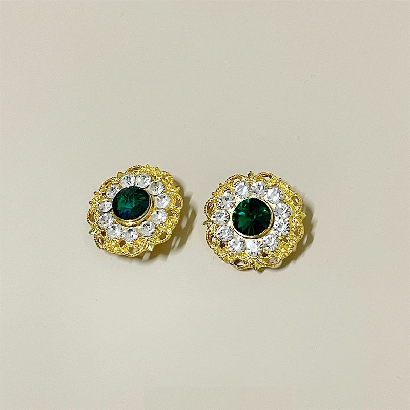 Two 26mm gold-tone buttons with green gemstone centers and crystal edges