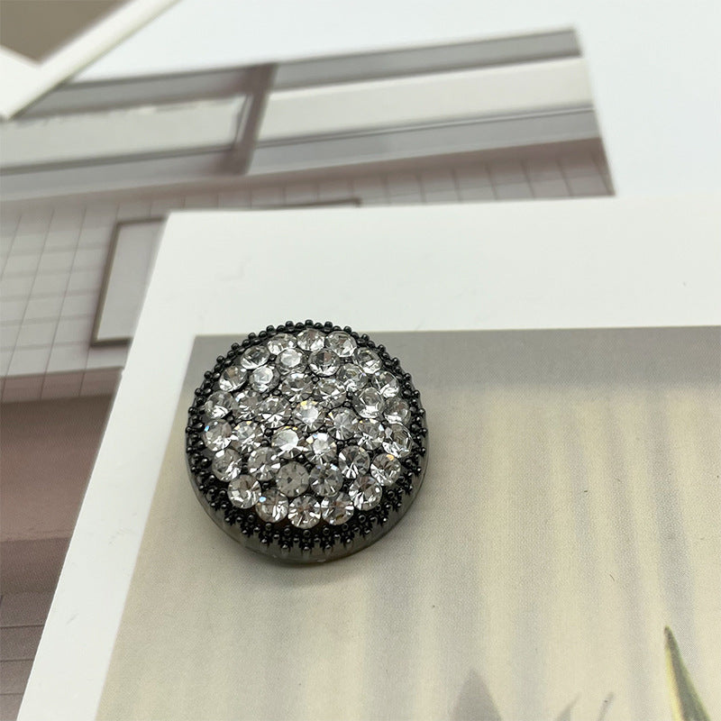 Round black rhinestone button with dark crystals and black metal edge