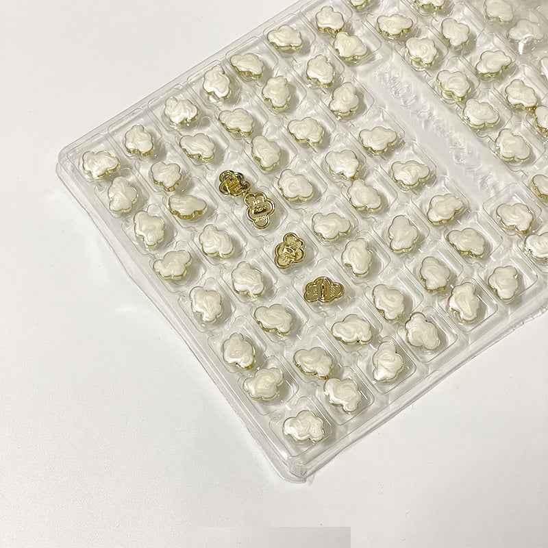 White cloud-shaped metal shank buttons, 12.5mm, in a blister tray