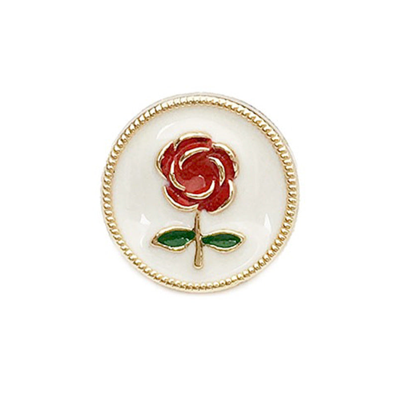 Round metal button: white base, red rose with green leaves, gold beaded rim
