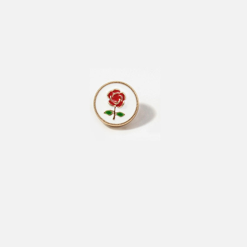 Round metal button with red rose and green leaves on white enamel, gold rim
