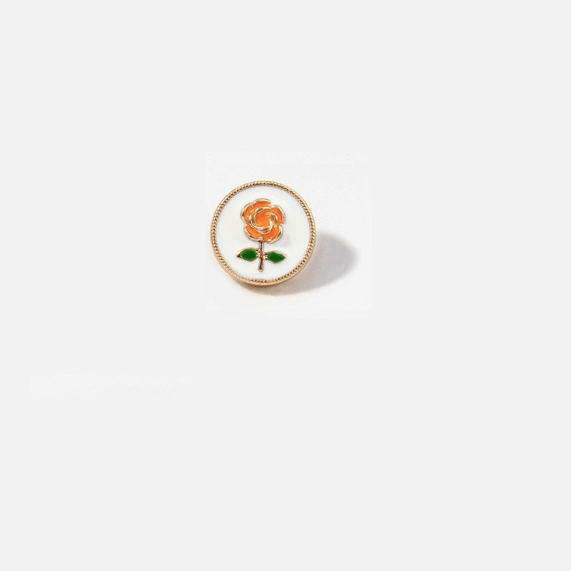 Round metal button with orange rose and green leaves on white enamel, gold rim