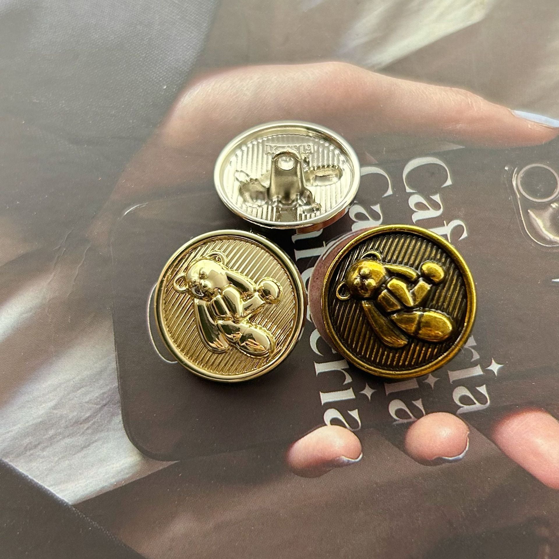 Three teddy bear metal buttons in gold, silver, and antique gold, round 3D fronts