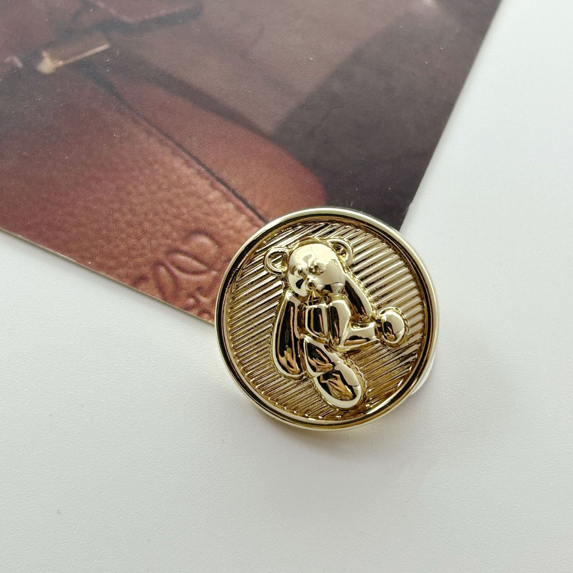 Gold teddy bear decorative metal button with attached shank, round textured design