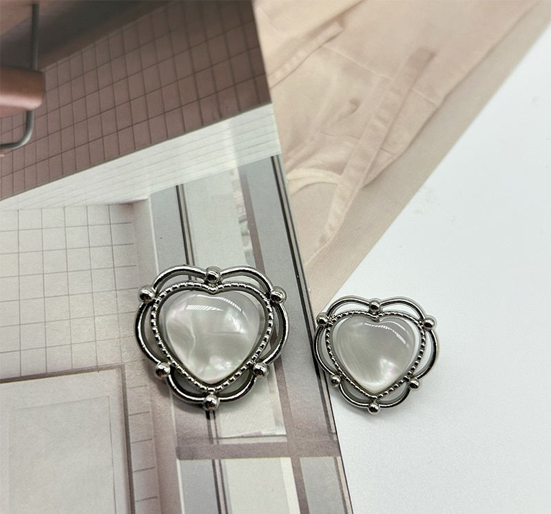 Heart-shaped resin buttons with silver two-tone rings and white domed center