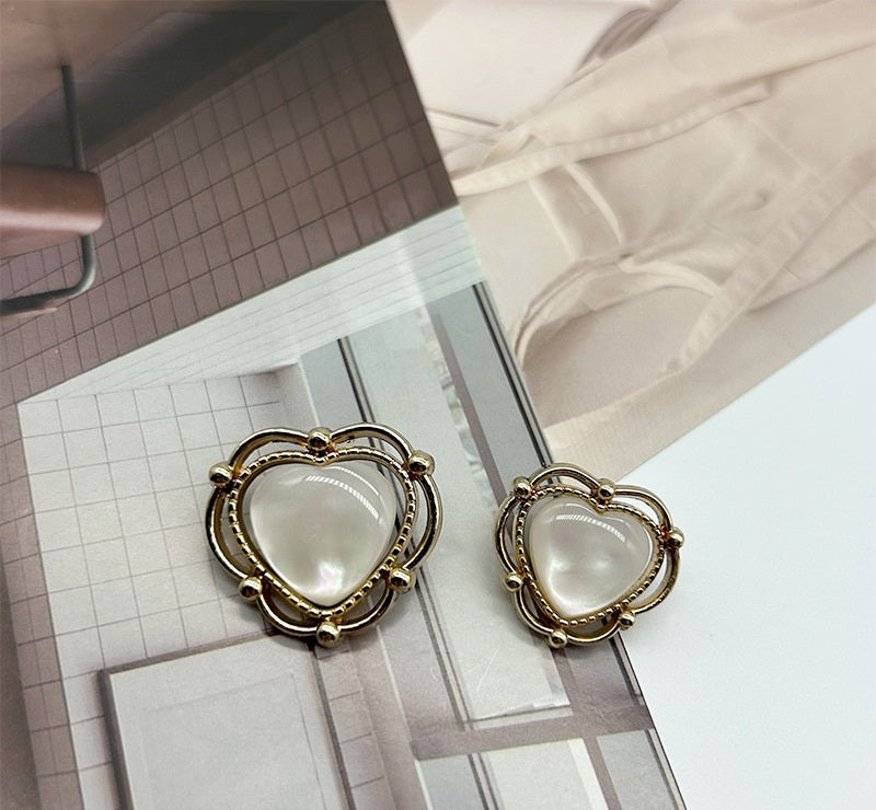 Gold-and-silver heart-shaped resin buttons with white domed center