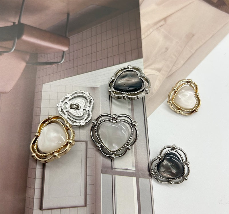 Heart-shaped resin buttons with two-tone metal halos: gold and silver, white centers