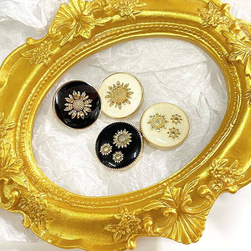 Sunflower metal shank buttons in black and white, gold flower design on round faces