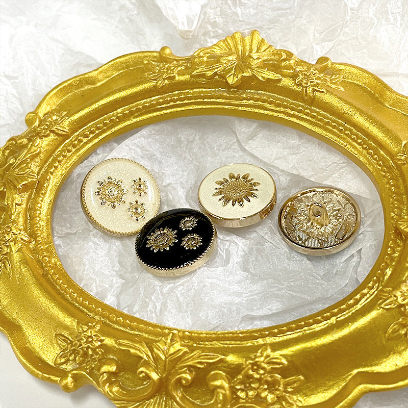 Set of sunflower metal shank buttons: black and white with gold painted flower motifs