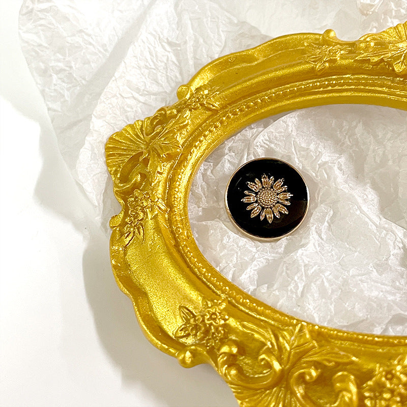 Black sunflower metal shank button, gold flower motif on dark round face