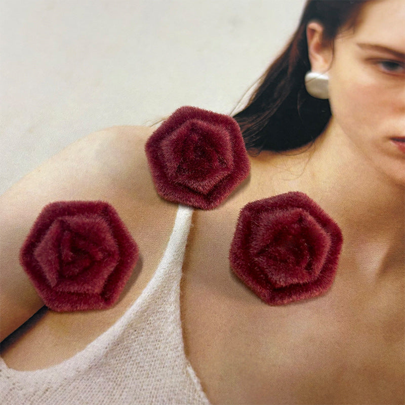 Three maroon flocked hexagonal rose buttons on jacket front
