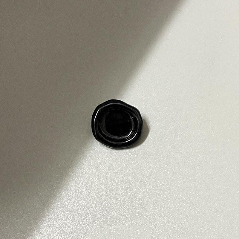 Black oval concave metal shank button (back view), 20mm