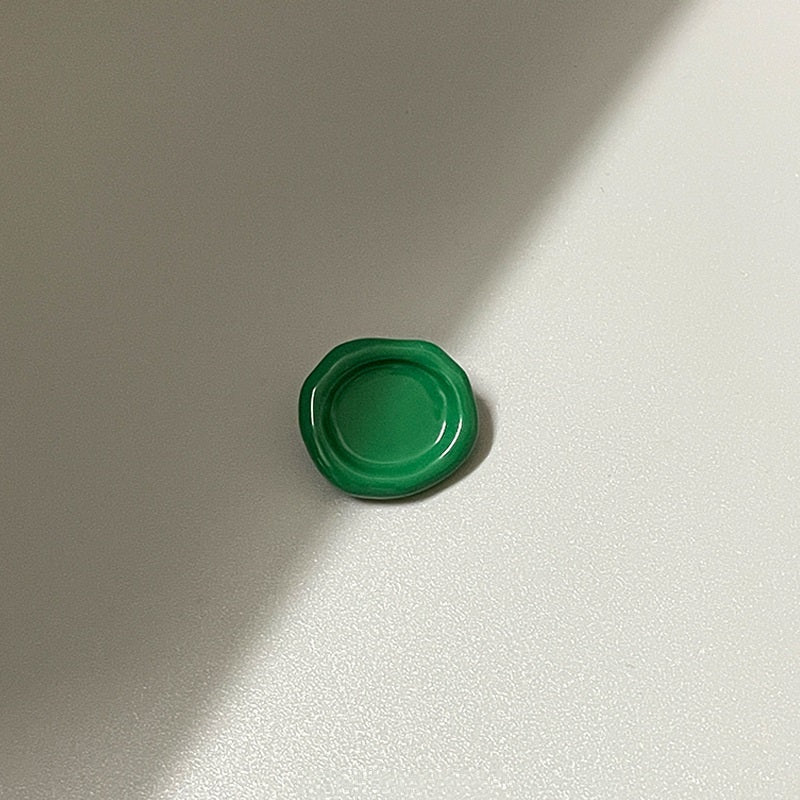Green oval concave metal shank button (back view), 20mm