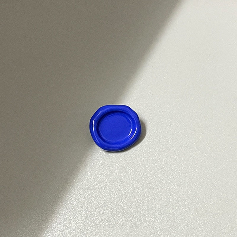 Blue oval concave metal shank button (back view), 20mm