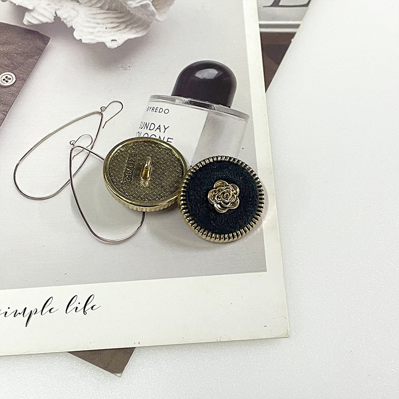 Flocked camellia metal button pair: gold-tone back and dark blue fabric with gold rose center