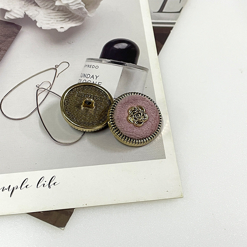 Flocked camellia metal button pair: gold-tone back and lavender fabric with gold rose center