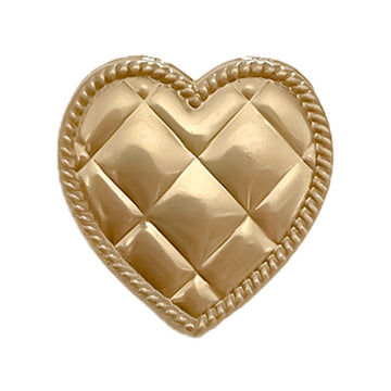 Botón de metal con forma de corazón, dorado brillante, acabado pulido y relieve geométrico