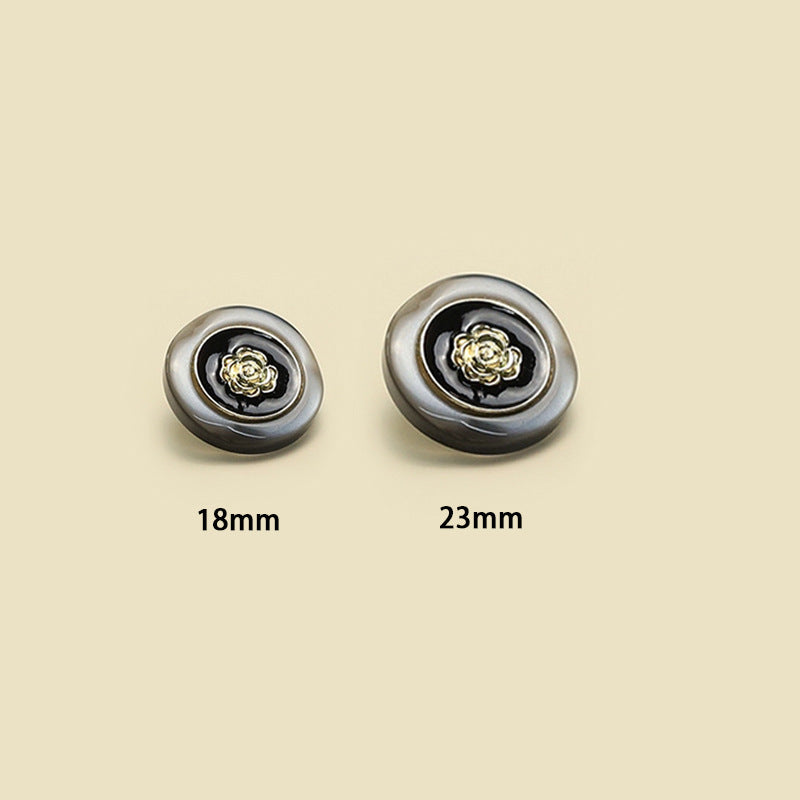 Camellia buttons in 18mm and 23mm: dark resin, gold-tone flower centers